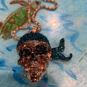 Gold Skull Pendant Necklace with Blue Accents. Betsey Johnson